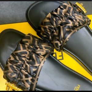 Women Fendi slides. Brown and Black with Gold hardware.